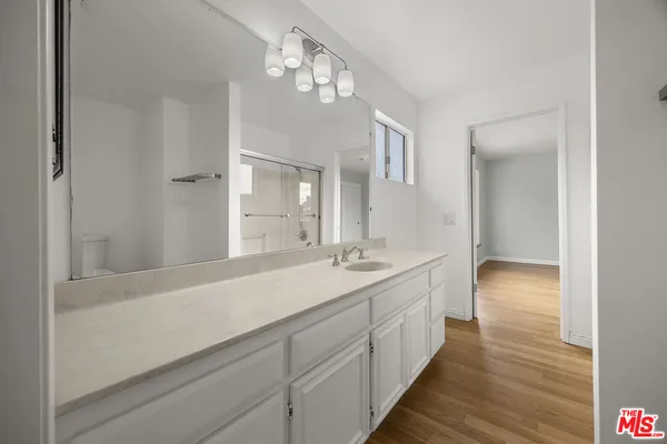 a bathroom with a double vanity sink and a mirror