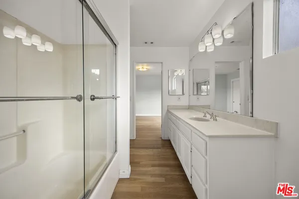 a bathroom with a double vanity sink and mirror