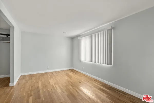 a view of an empty room and wooden floor
