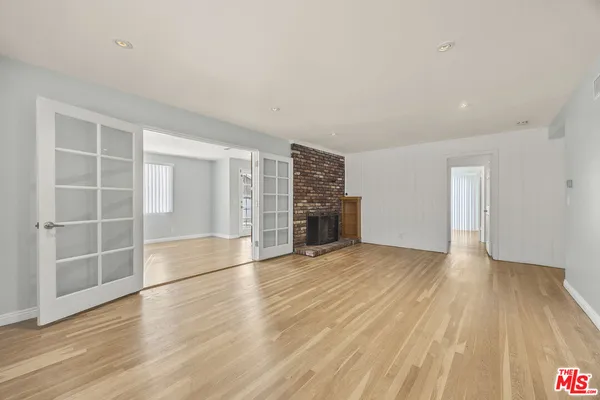 an empty room with wooden floor and closet