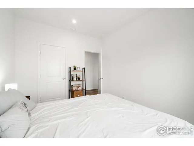 a bedroom with a bed and a lamp