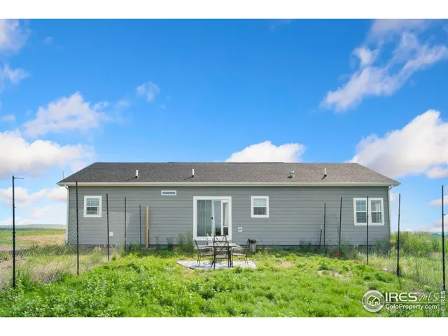 a view of backyard of house with green space
