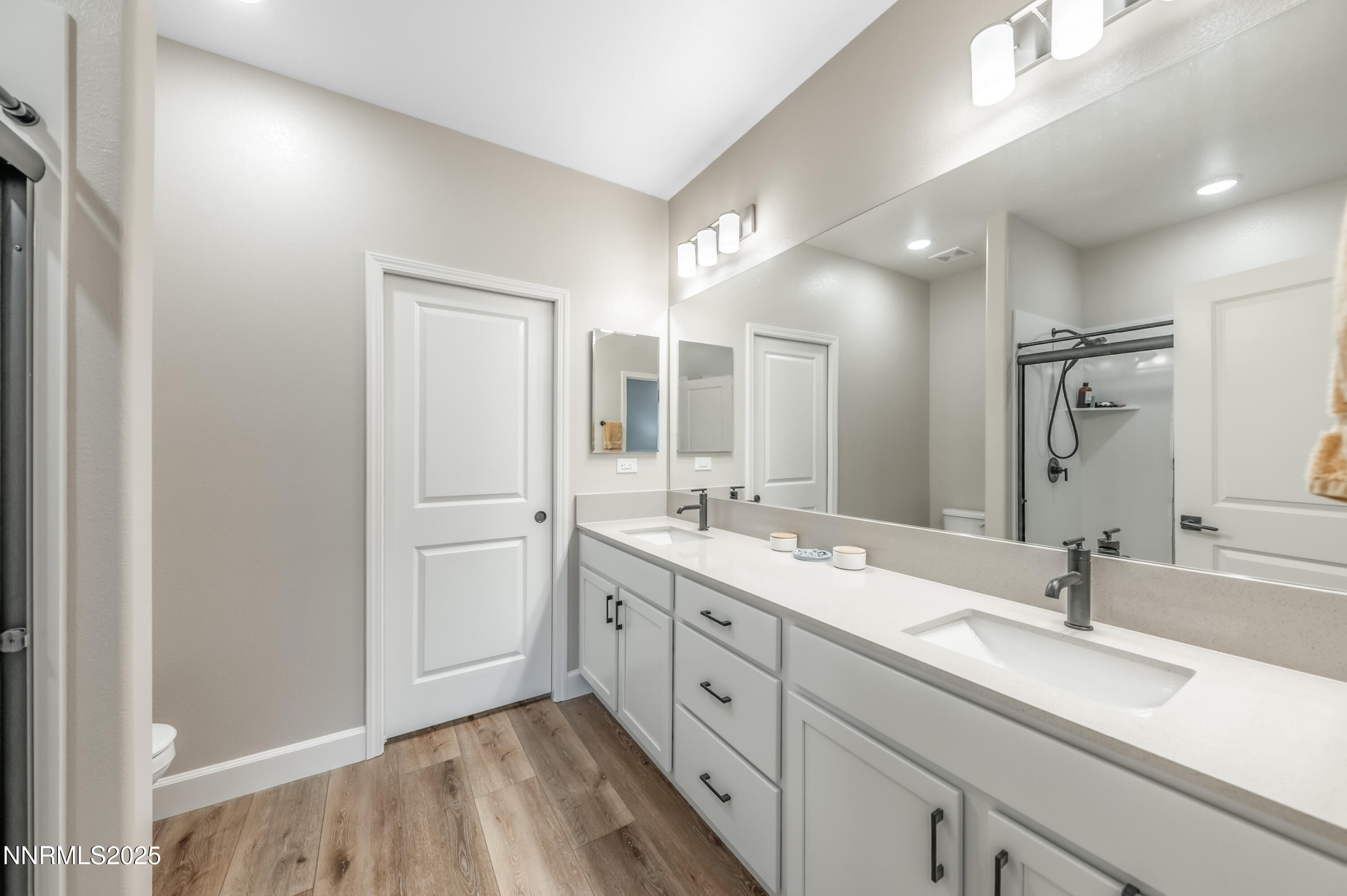 10834 Farmstead Lane Reno, NV 89521 - Photo 12 of 20 a spacious bathroom with a double vanity sink and mirror