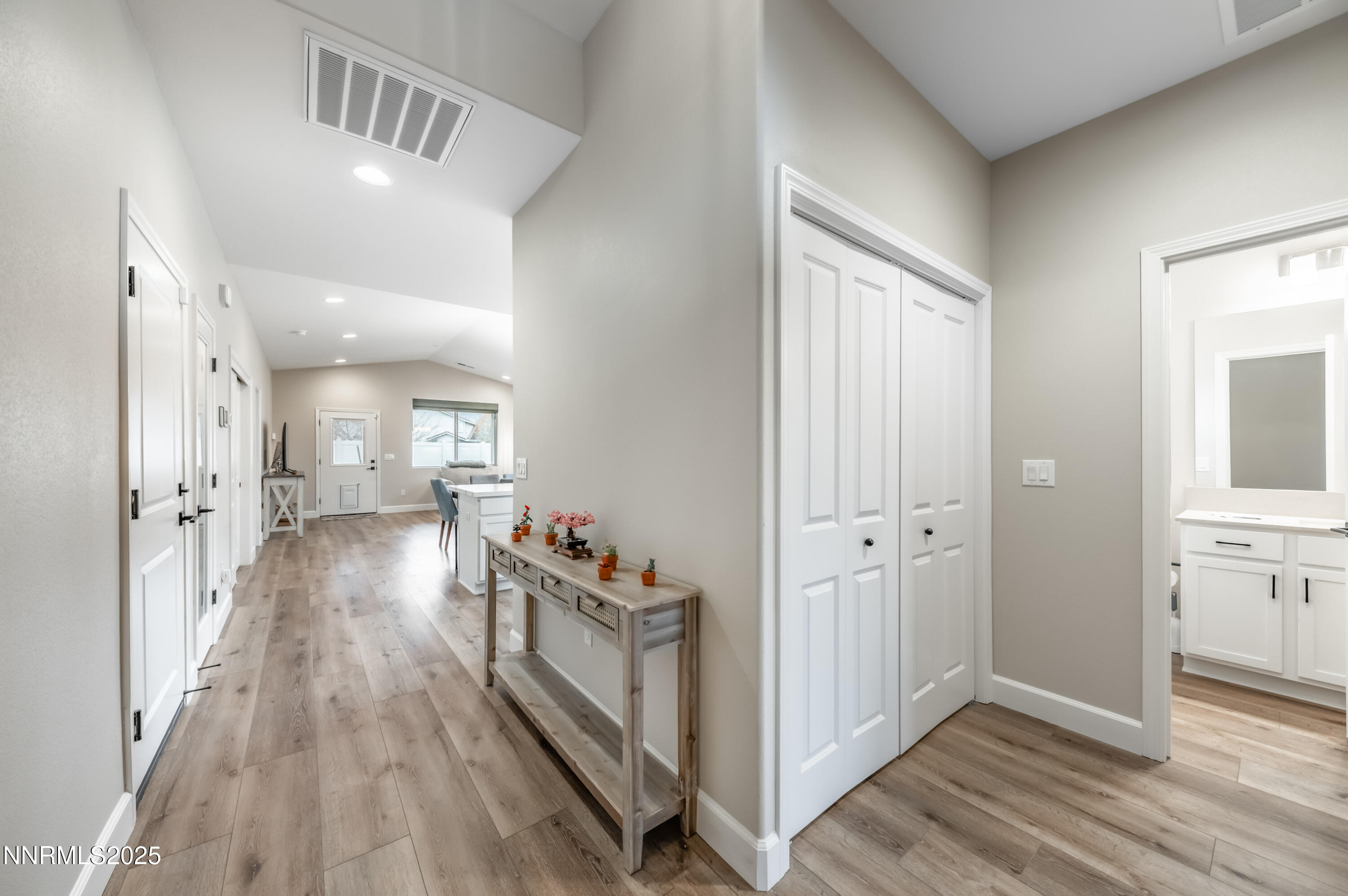 10834 Farmstead Lane Reno, NV 89521 - Photo 3 of 20 a view of a hallway with wooden floor and staircase
