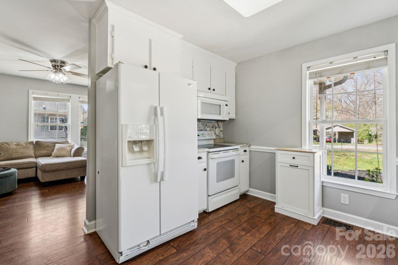 610 Eddleman Road Kannapolis, NC 28083 - Photo 12 of 34 a kitchen with white cabinets and wooden floor