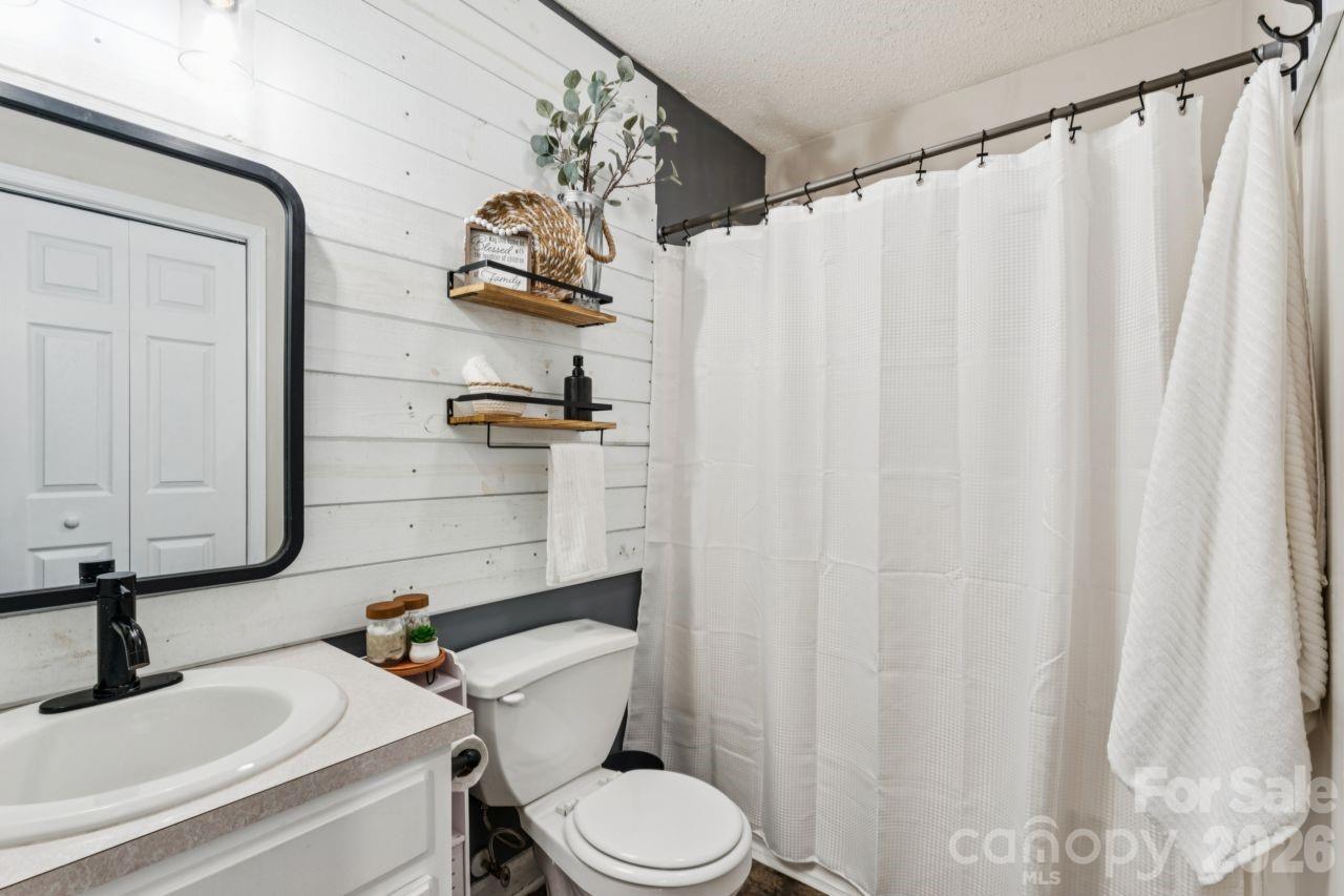 610 Eddleman Road Kannapolis, NC 28083 - Photo 16 of 34 a bathroom with a sink a toilet and a mirror