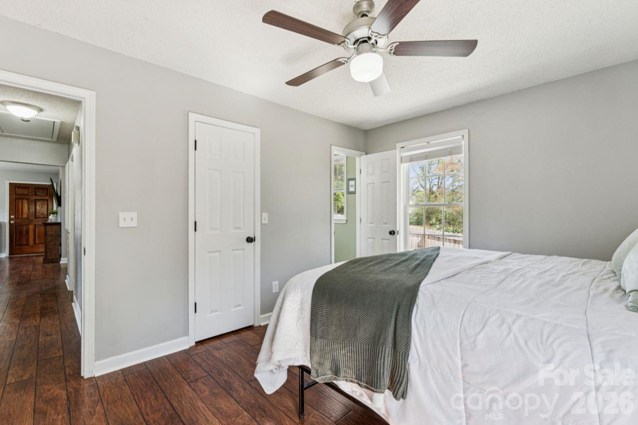 610 Eddleman Road Kannapolis, NC 28083 - Photo 20 of 34 a spacious bedroom with a bed and a chandelier