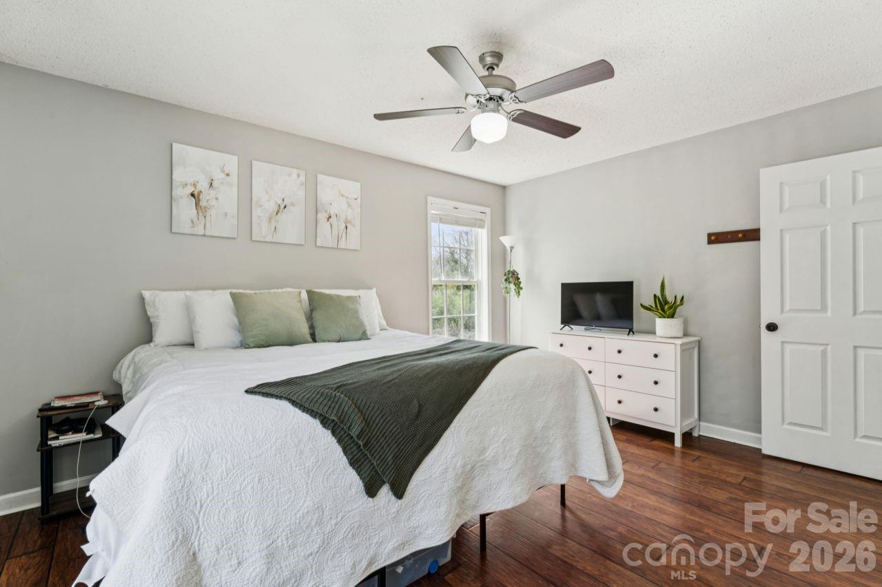 610 Eddleman Road Kannapolis, NC 28083 - Photo 22 of 34 a spacious bedroom with a bed and a flat screen tv