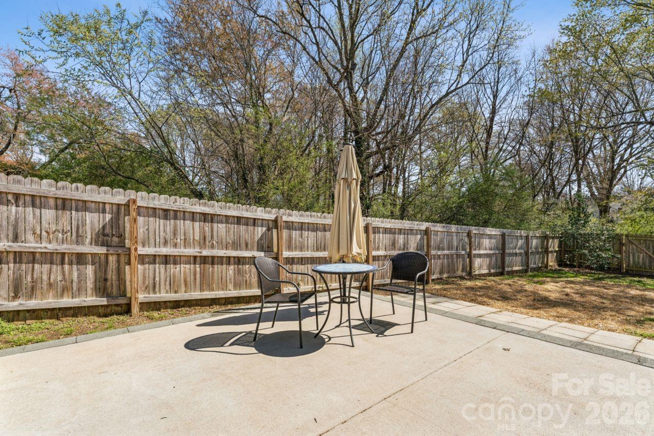 610 Eddleman Road Kannapolis, NC 28083 - Photo 29 of 34 a view of a patio with a table and chairs and wooden fence