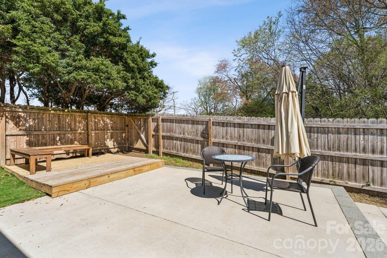 610 Eddleman Road Kannapolis, NC 28083 - Photo 30 of 34 a view of a patio with a table and chairs and wooden fence