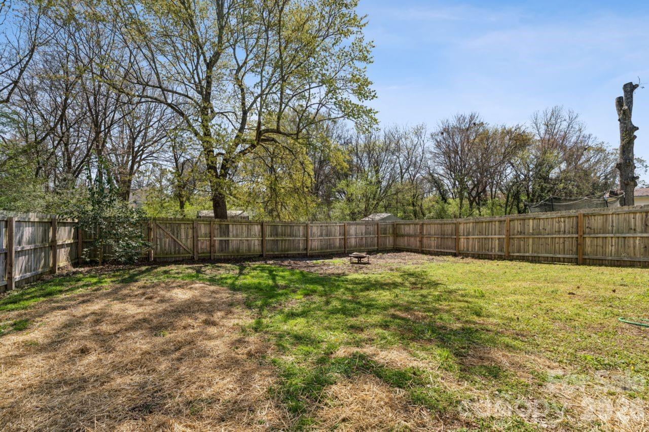 610 Eddleman Road Kannapolis, NC 28083 - Photo 31 of 34 a white house with a yard and wooden fence