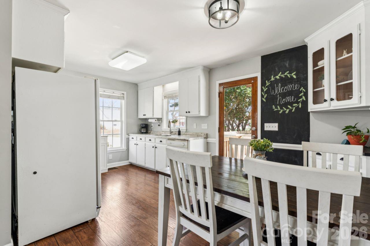 610 Eddleman Road Kannapolis, NC 28083 - Photo 9 of 34 a kitchen with kitchen island granite countertop lots of white cabinets and wooden floor
