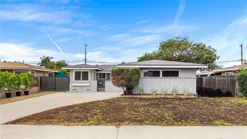 13361 Roxey Drive Garden Grove, CA 92843 - Photo 28 of 31 a front view of a house with a yard and potted plants