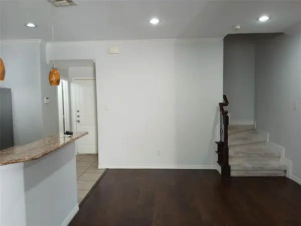 a kitchen with stainless steel appliances granite countertop a sink a stove a refrigerator and a microwave