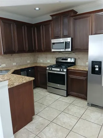 a kitchen with a sink cabinets and window