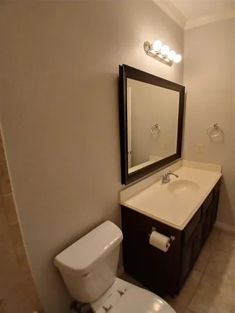 a white toilet and tub sitting next to a bathroom sink