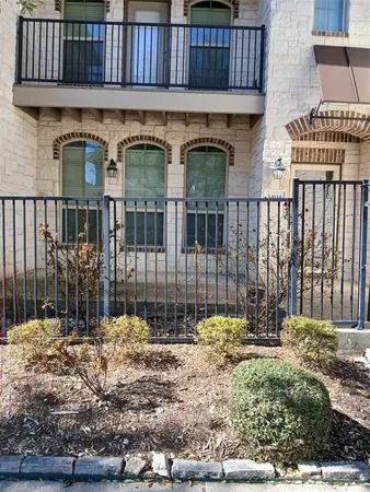 a view of an empty room with wooden floor and a fireplace