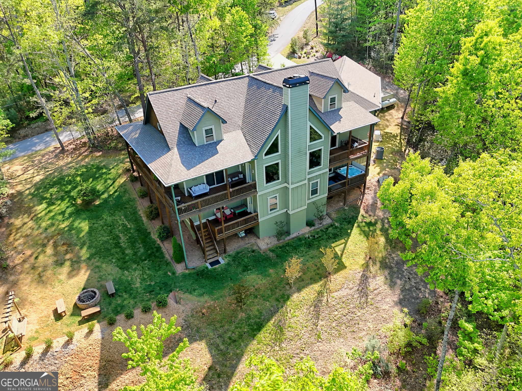 421 Hickory Nut Mountain Road Tallulah Falls, GA 30573 - Photo 106 of 117 a view of a house with a yard and sitting area