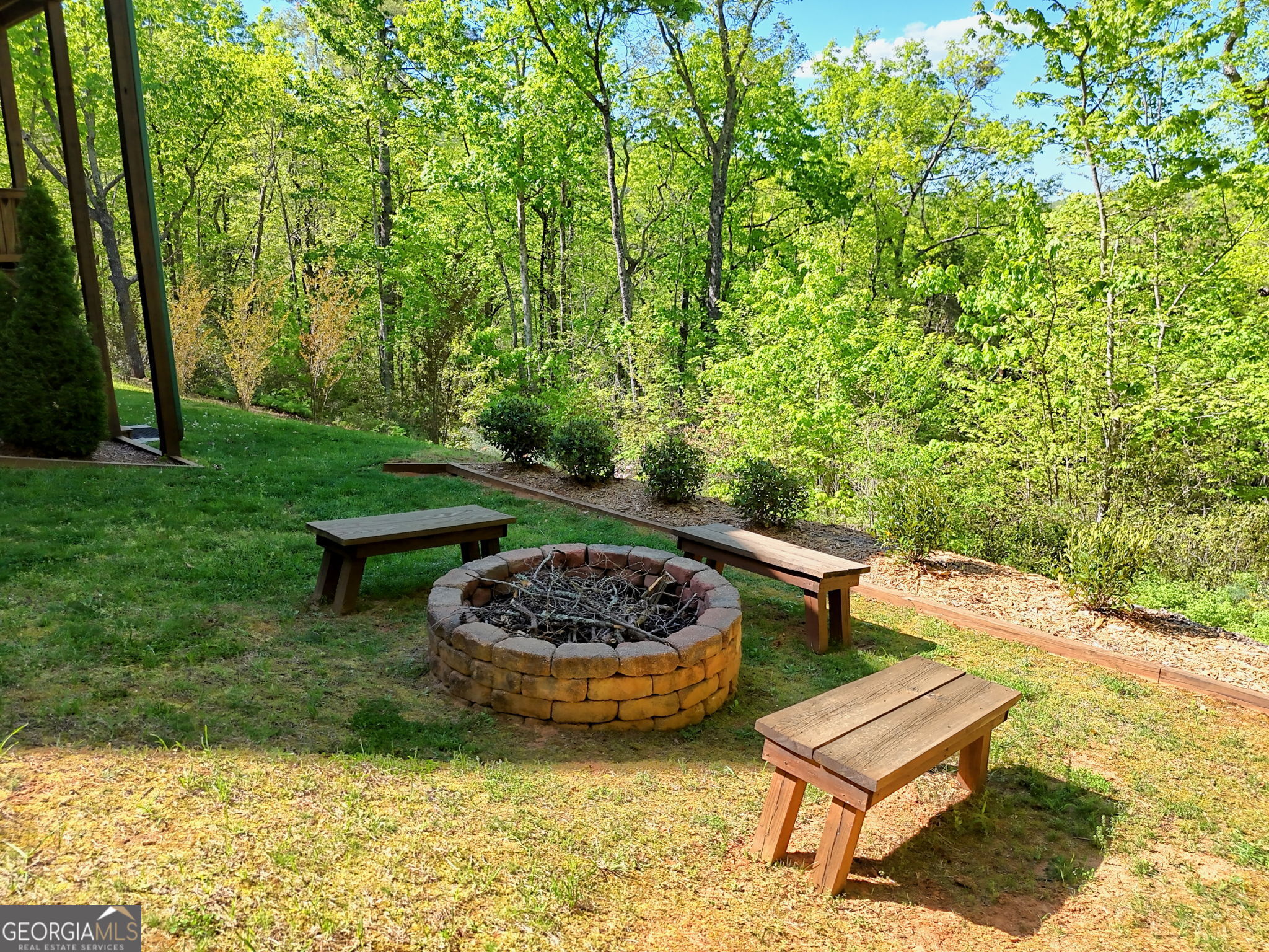 421 Hickory Nut Mountain Road Tallulah Falls, GA 30573 - Photo 110 of 117 a view of a backyard with plants and a patio