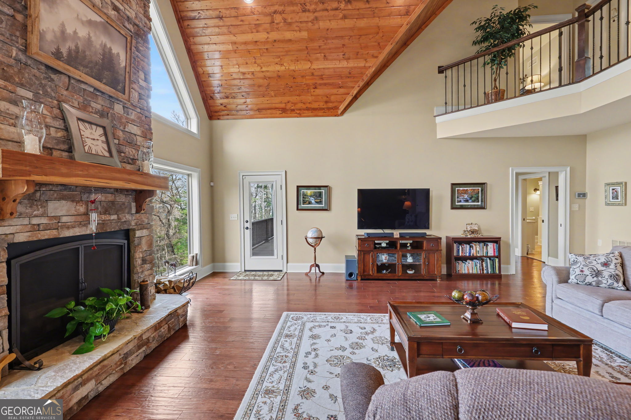 421 Hickory Nut Mountain Road Tallulah Falls, GA 30573 - Photo 36 of 117 a living room with furniture a flat screen tv and a fireplace