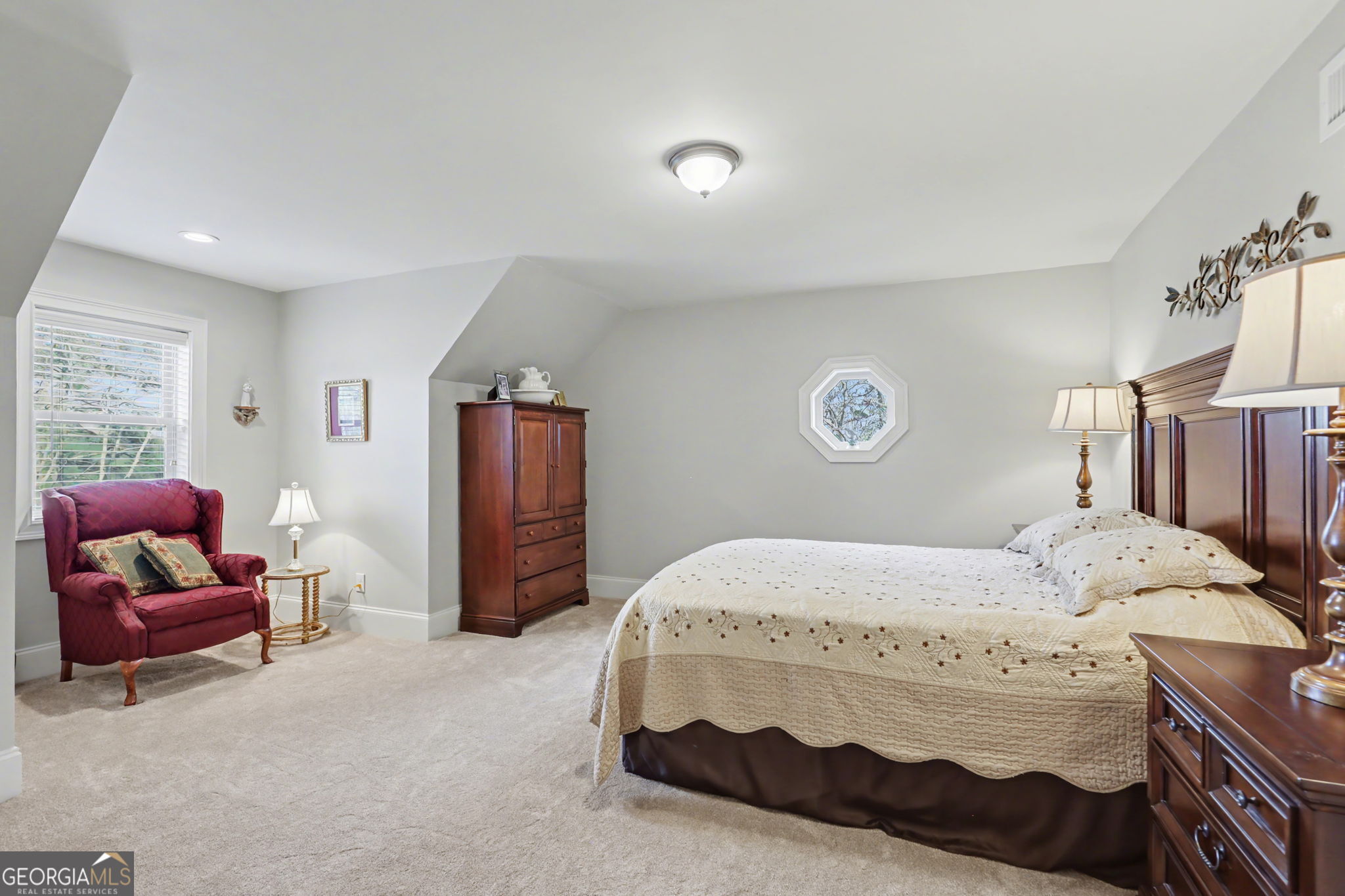 421 Hickory Nut Mountain Road Tallulah Falls, GA 30573 - Photo 46 of 117 a bedroom with a bed and dresser with mirror