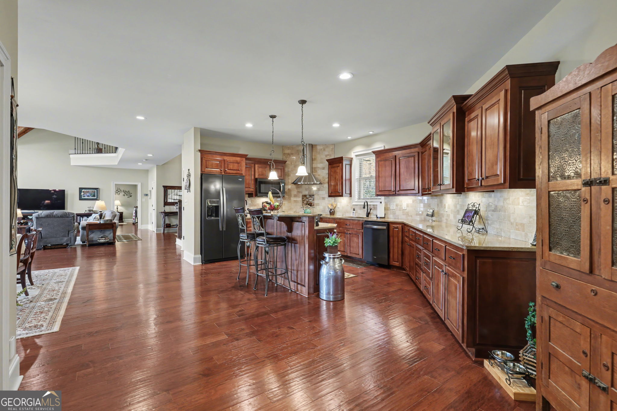 421 Hickory Nut Mountain Road Tallulah Falls, GA 30573 - Photo 62 of 117 a kitchen with stainless steel appliances kitchen island granite countertop wooden floors and a view of living room