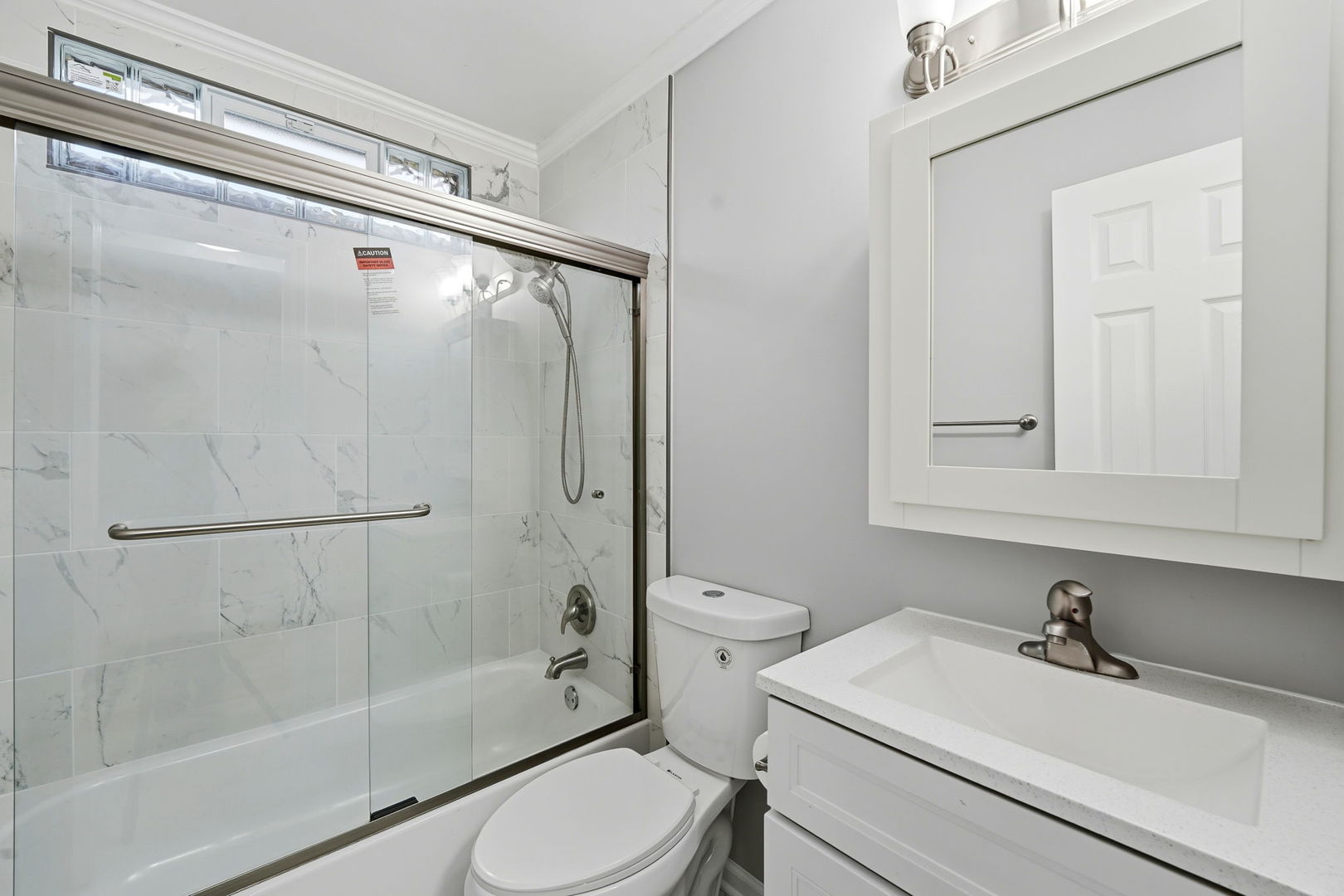 210 Willow Road Streamwood, IL 60107 - Photo 12 of 26 a bathroom with a sink toilet and shower