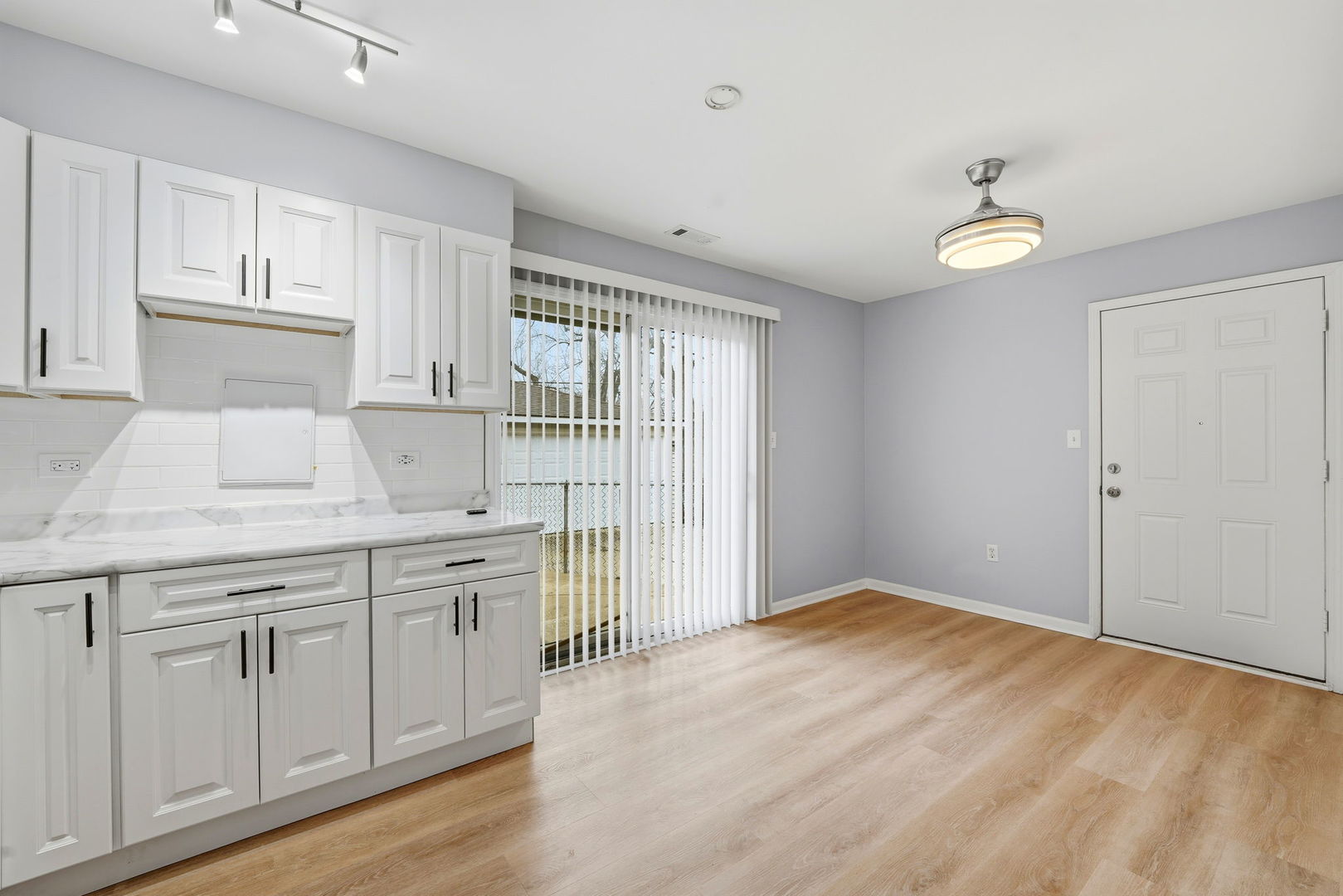 210 Willow Road Streamwood, IL 60107 - Photo 13 of 26 a kitchen with granite countertop a white cabinets and sink