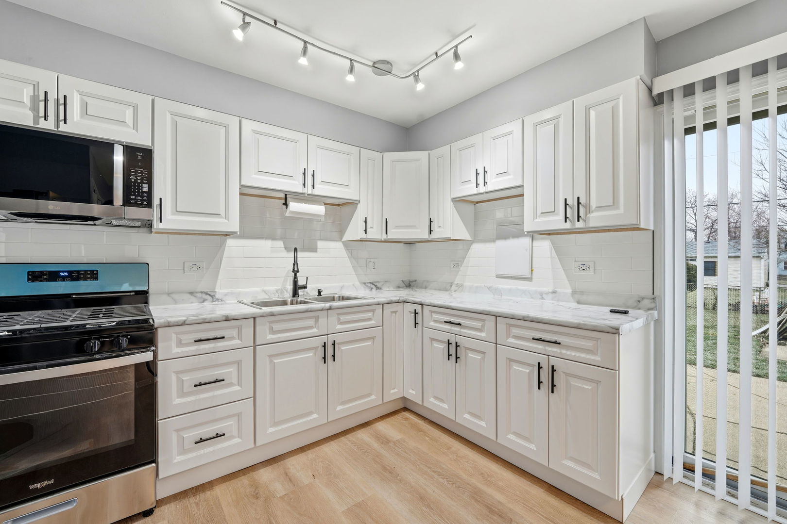 210 Willow Road Streamwood, IL 60107 - Photo 14 of 26 a kitchen with a sink stove and microwave