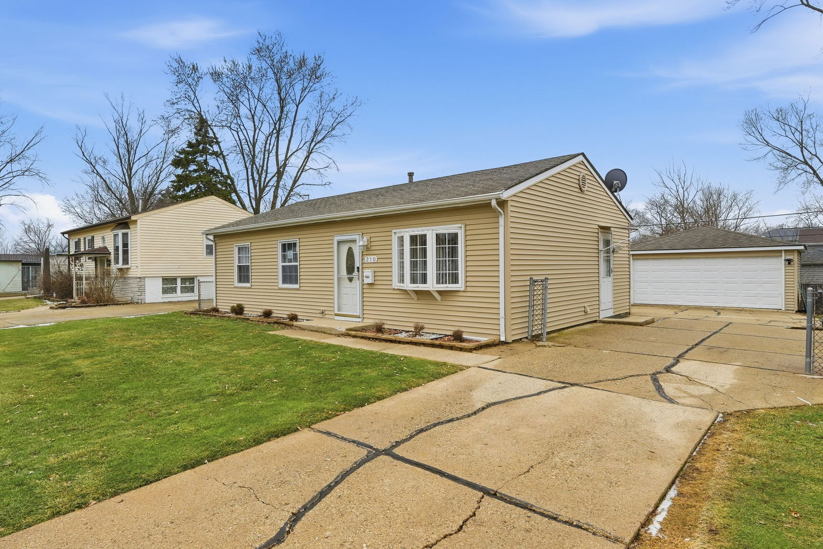 210 Willow Road Streamwood, IL 60107 - Photo 2 of 26 a front view of a house with a garden and yard