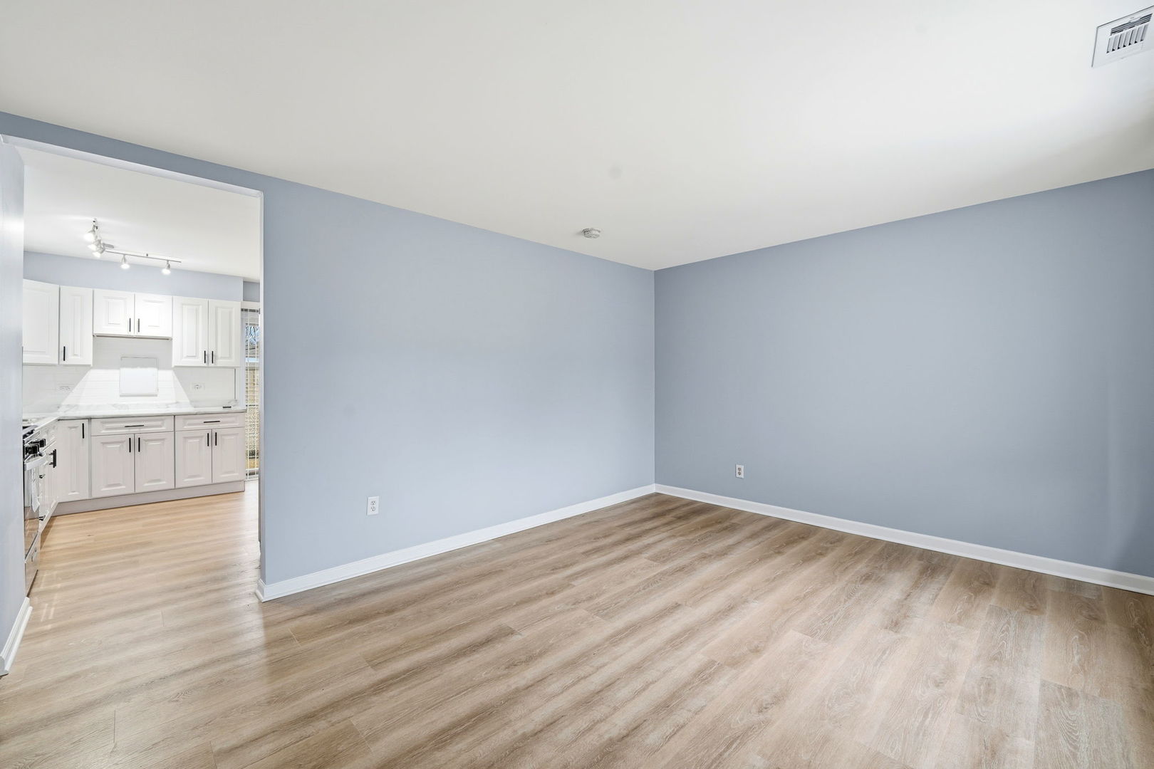 210 Willow Road Streamwood, IL 60107 - Photo 4 of 26 a view of a kitchen with wooden floor and a sink