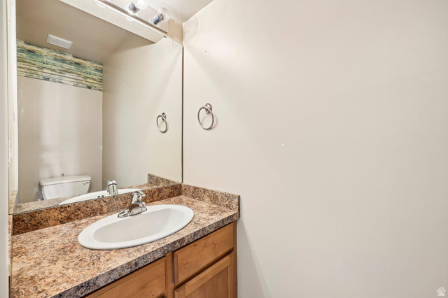 3215 West 450 North West Point, UT 84015 - Photo 25 of 40 Bathroom vanity featuring an oval undermount sink, a chrome faucet, and a patterned countertop