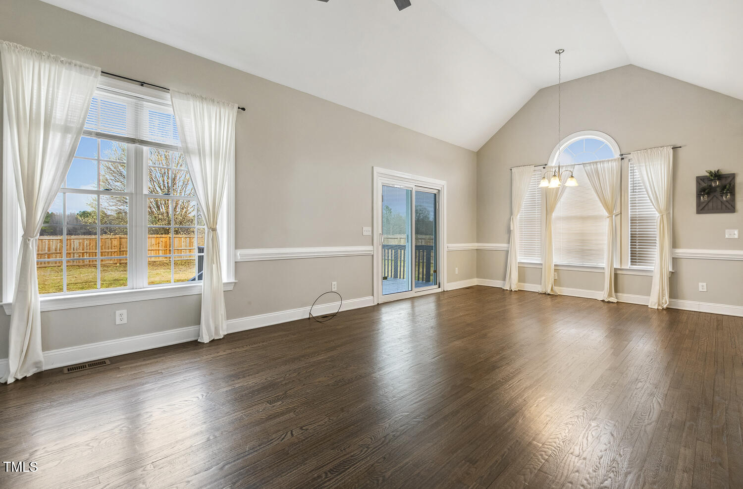 124 D'Ango Circle Angier, NC 27501 - Photo 14 of 42 a view of an empty room with wooden floor and a window