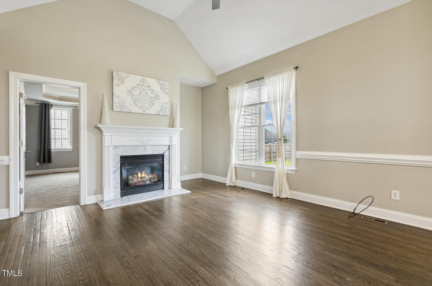 124 D'Ango Circle Angier, NC 27501 - Photo 15 of 42 a view of an empty room with wooden floor and a window