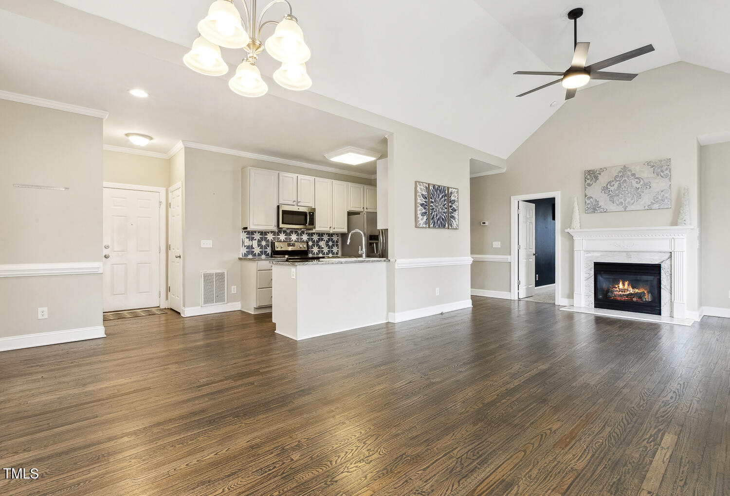 124 D'Ango Circle Angier, NC 27501 - Photo 18 of 42 a view of a kitchen with a stove wooden floor and a ceiling fan