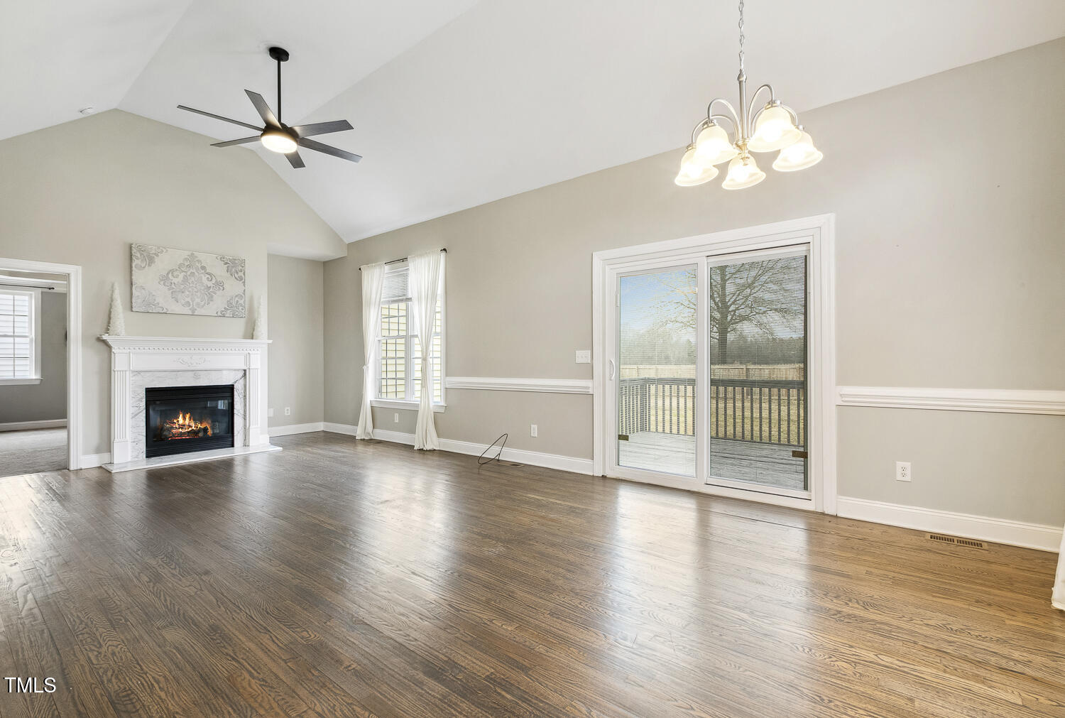 124 D'Ango Circle Angier, NC 27501 - Photo 19 of 42 a view of an empty room with wooden floor and a window
