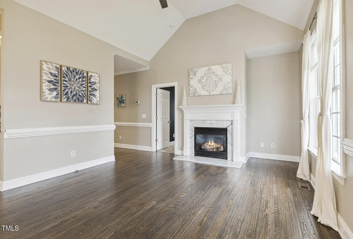 124 D'Ango Circle Angier, NC 27501 - Photo 21 of 42 an empty room with wooden floor a fireplace and windows