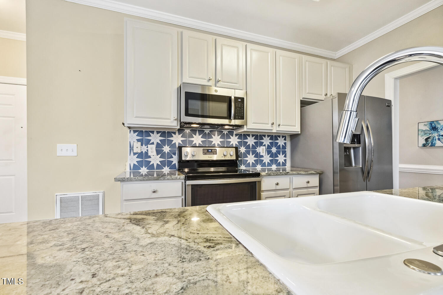124 D'Ango Circle Angier, NC 27501 - Photo 27 of 42 a kitchen with granite countertop a refrigerator stove and microwave