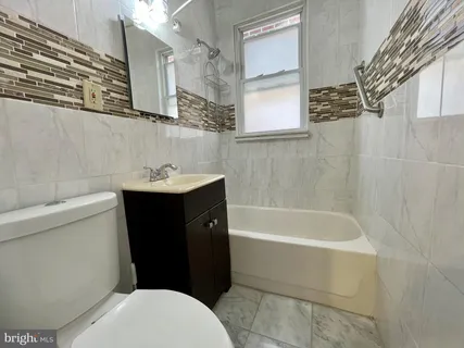 a bathroom with a sink a toilet and bathtub