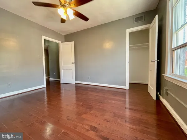wooden floor in an empty room with a window