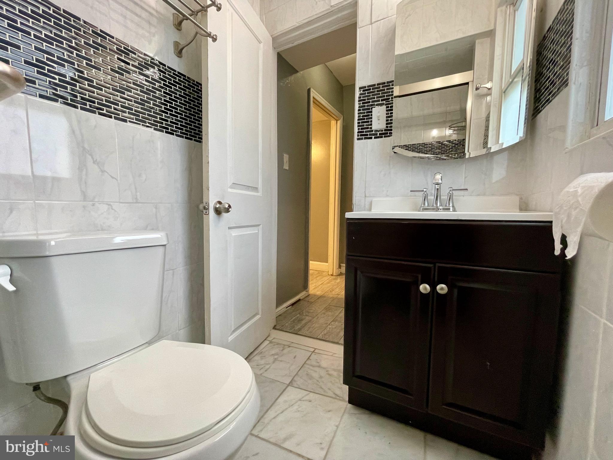 1858 Kendall Street Northeast, Unit 2 Washington, DC 20002 - Photo 24 of 38 a bathroom with a sink a toilet and shower