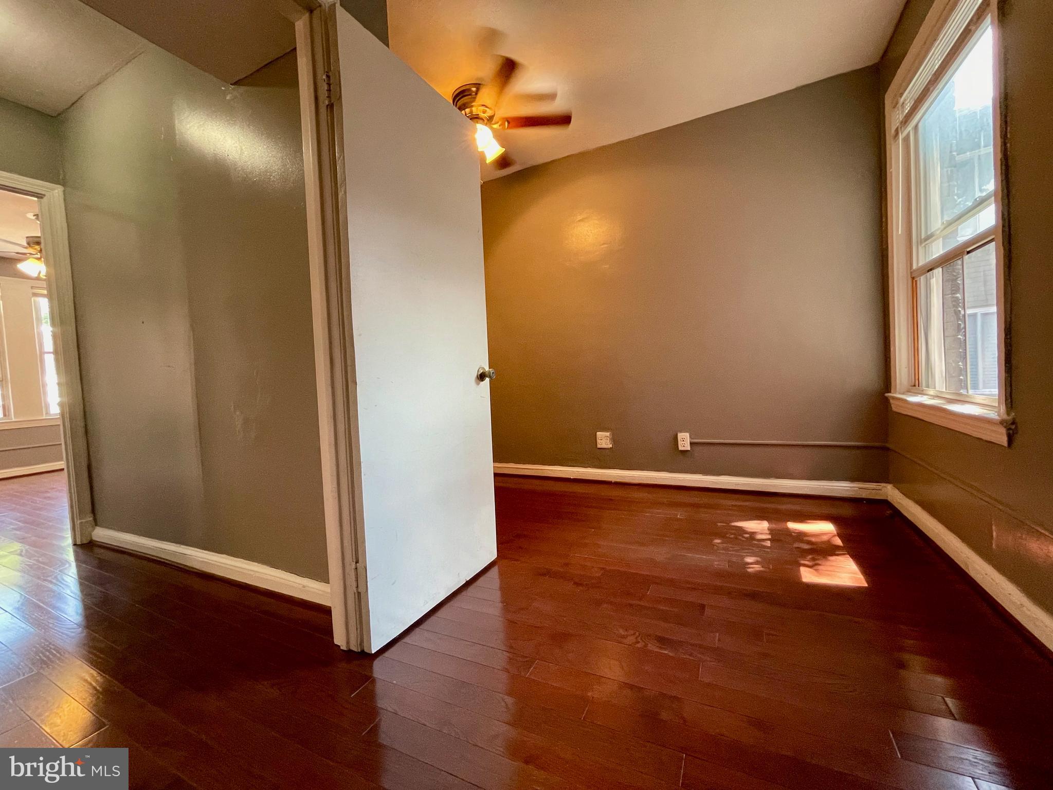 1858 Kendall Street Northeast, Unit 2 Washington, DC 20002 - Photo 27 of 38 an empty room with wooden floor and windows