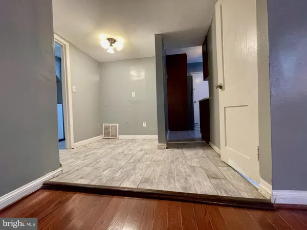 a view of kitchen and hall with wooden floor