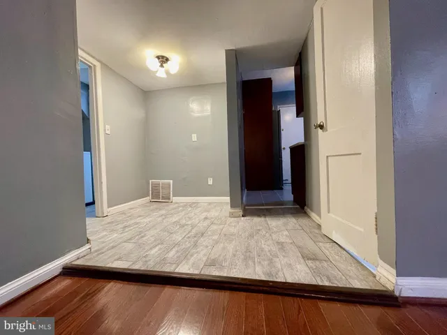 a view of kitchen and hall with wooden floor