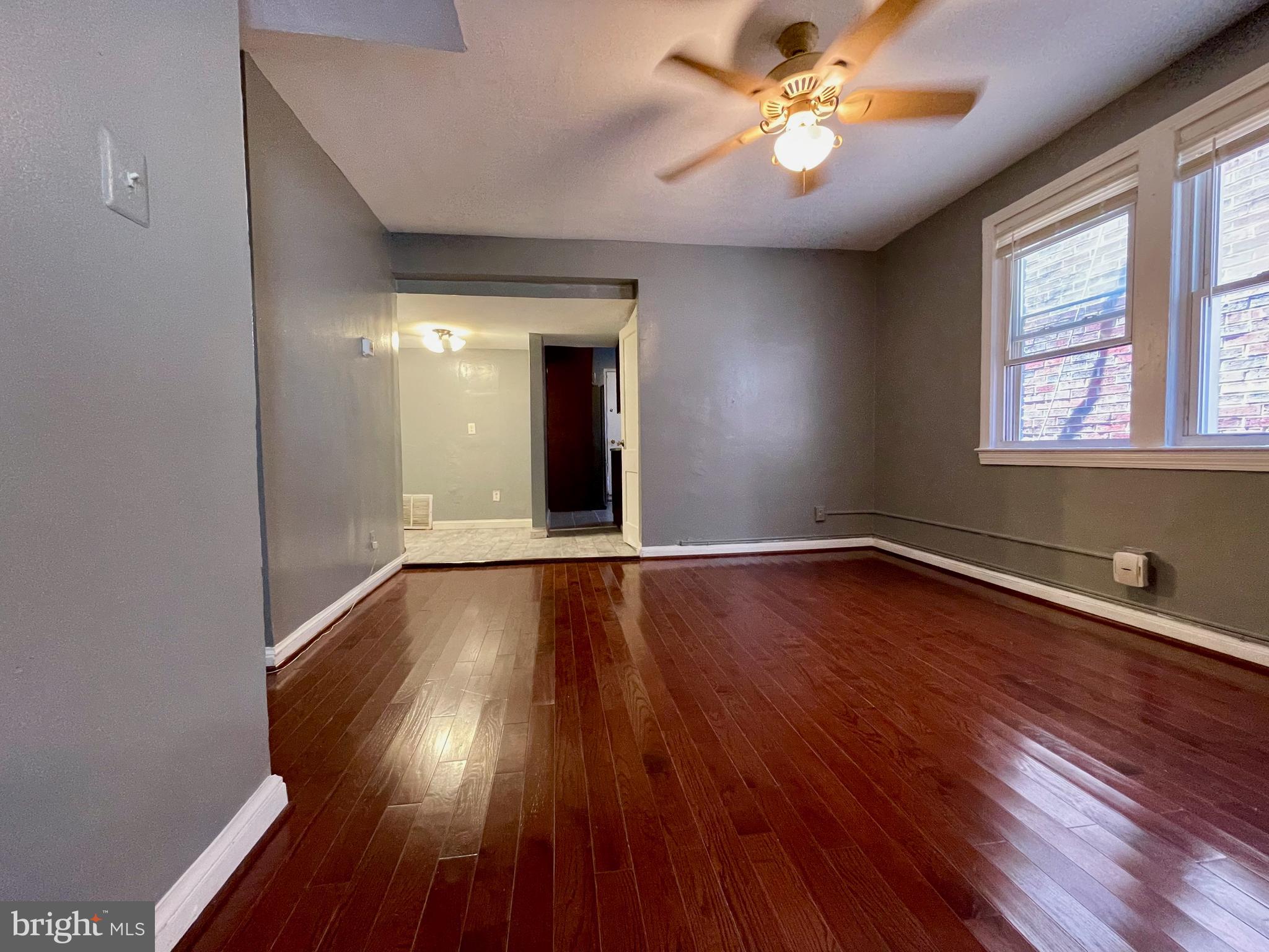 1858 Kendall Street Northeast, Unit 2 Washington, DC 20002 - Photo 9 of 38 a view of an empty room with wooden floor and a window