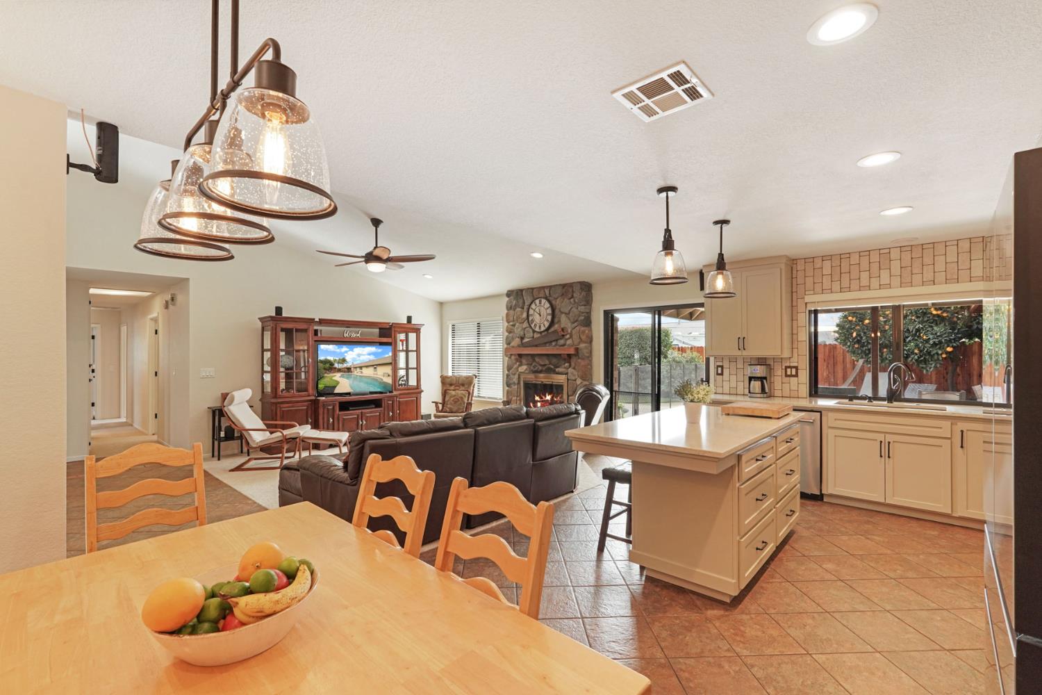 764 Adare Way Galt, CA 95632 - Photo 11 of 59 a room with stainless steel appliances kitchen island granite countertop furniture and a fireplace