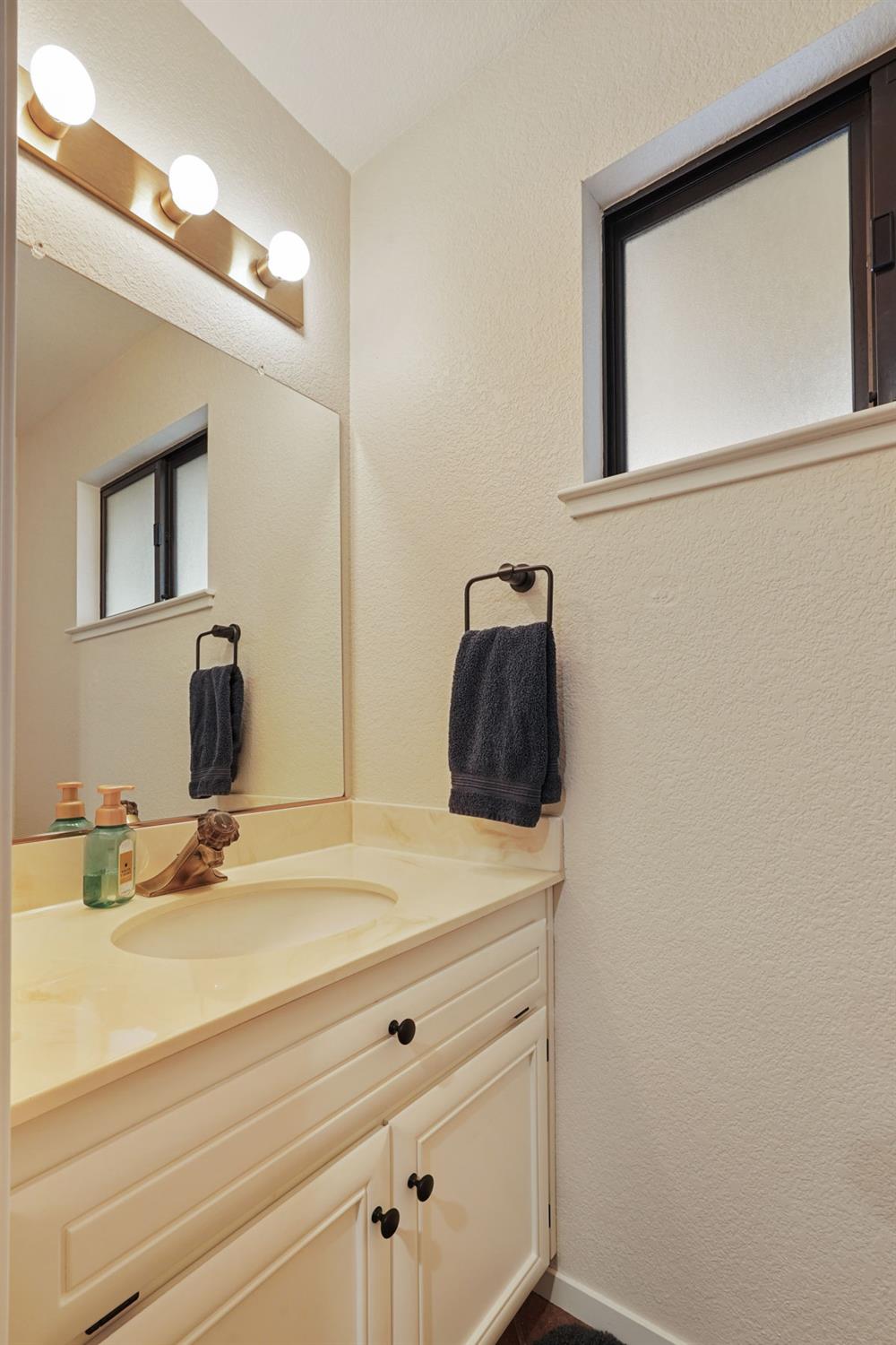 764 Adare Way Galt, CA 95632 - Photo 13 of 59 a bathroom with a sink and a mirror