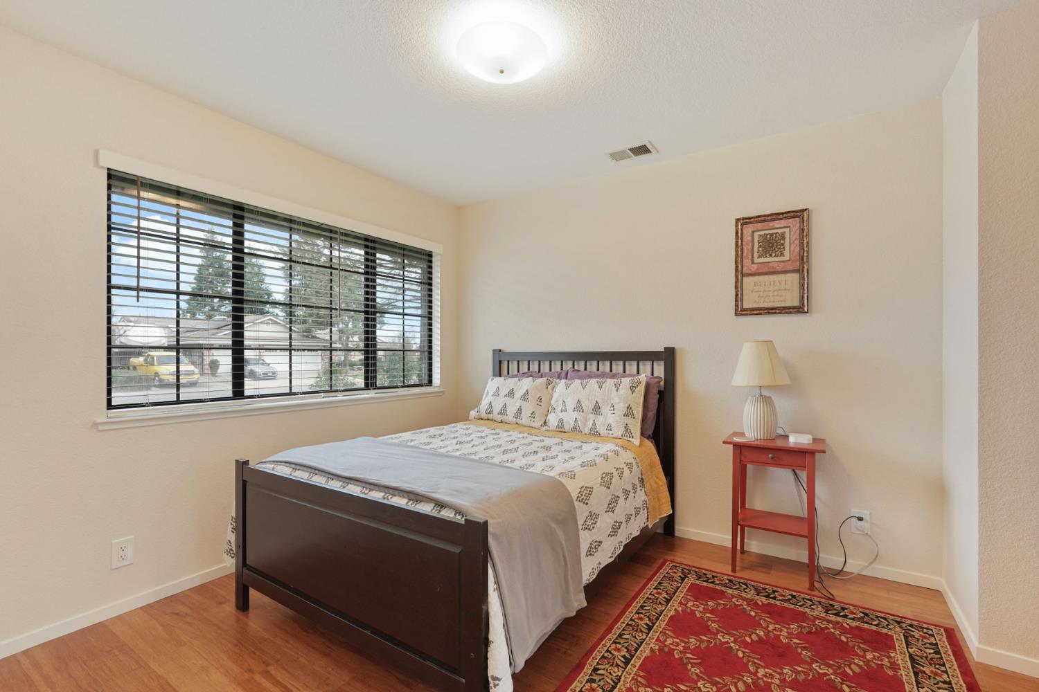 764 Adare Way Galt, CA 95632 - Photo 18 of 59 a bed sitting in a bedroom next to a window