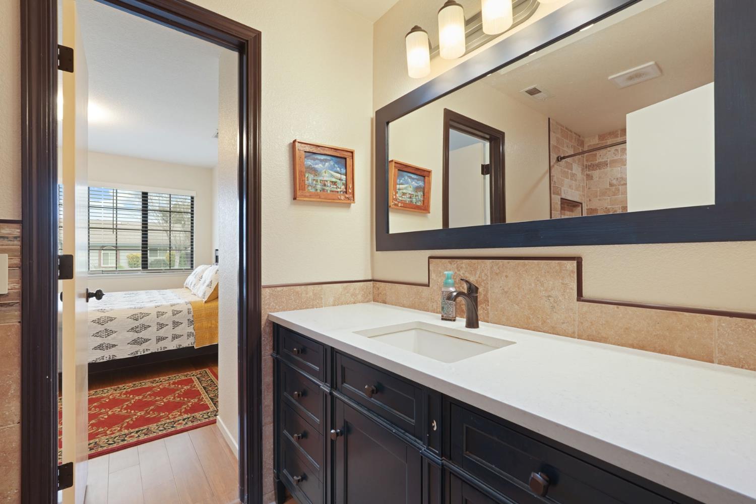 764 Adare Way Galt, CA 95632 - Photo 21 of 59 a en suite bathroom with a sink and mirror