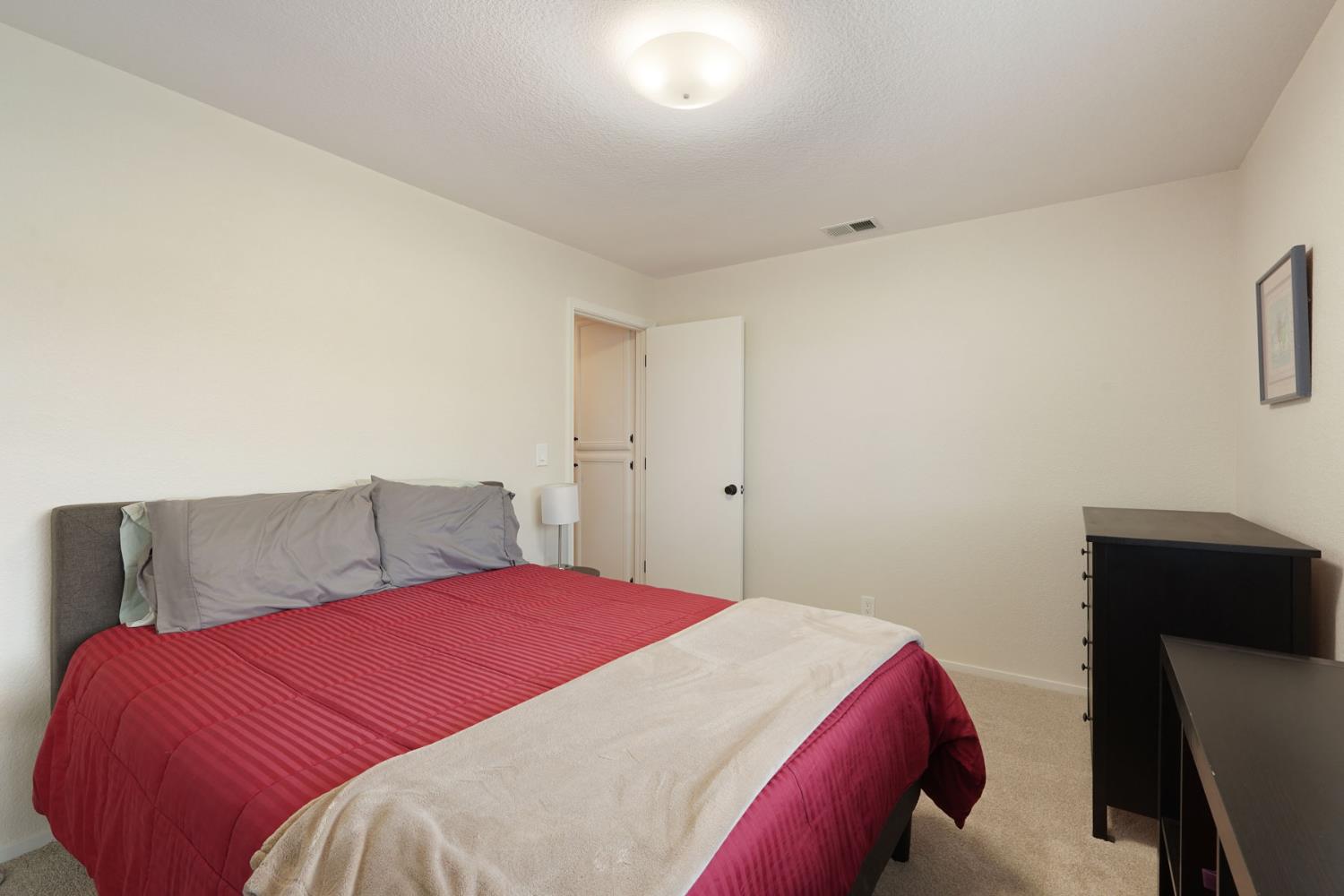 764 Adare Way Galt, CA 95632 - Photo 26 of 59 a bedroom with a bed and a chair